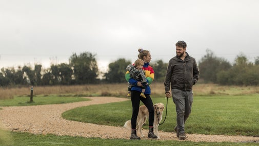 A couple with a dog walking at Tinkley Gate